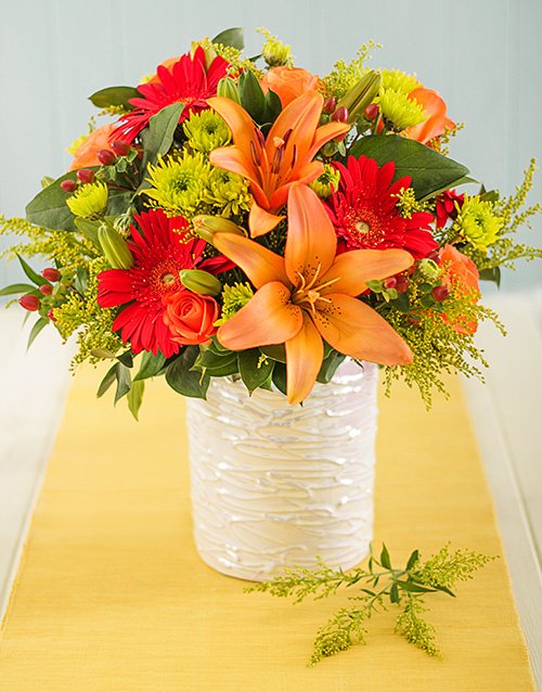 Fiery Mixed Flowers in Glazed Vase